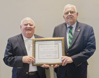 Lawrence J. Baker (left) receives the CNY&nbsp;RPDB's Rhea Eckel Clark Citizenship Award from Board Chairman James J. Murphy, Jr., at the Board's 2018 Annual Meeting